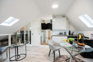 a kitchen and dining room with a glass table and chairs at Spacious and Modern studio in London G in London