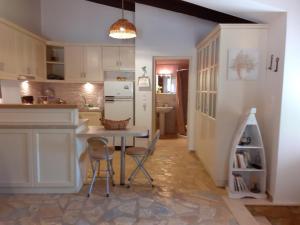 a kitchen with a table and chairs in a room at Studio Matina in Valsamáta