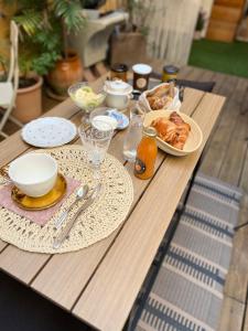 a wooden table with plates of food on it at Le Paillé de Torreilles in Torreilles