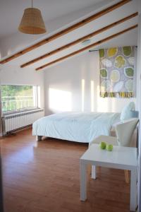 a bedroom with a bed and a table with a laptop at Villa Chingo in Ohrid