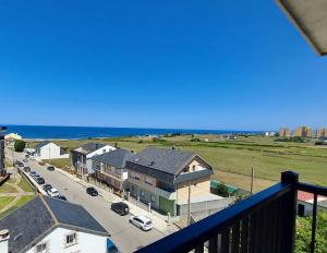 a view of a street with houses and the ocean at Masquestar Rías Altas in Foz