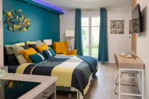 a bedroom with a bed and a table and chairs at LILYA HOUSE in Saint-Pierre-du-Perray