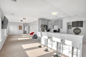 a kitchen with white cabinets and white counter tops at Stunning Beachfront Queens Getaway townhouse in Far Rockaway