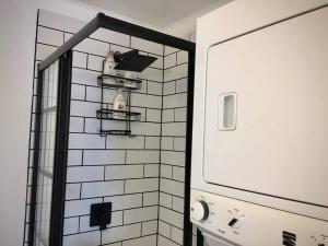 a bathroom with a mirror and a white tiled wall at Parkman Pad in Montague in Montague