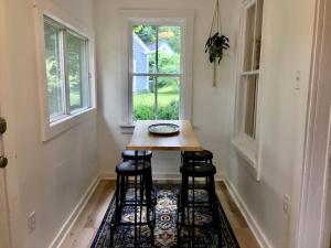 a small table in a room with two windows at Parkman Pad in Montague in Montague +28 photos