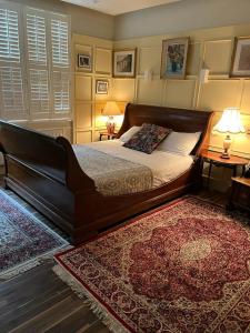 a bedroom with a large bed and a rug at The Galaxie in Oxford