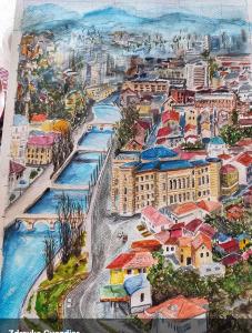 een schilderij van een stad en de oceaan bij Vjećna vatra in Sarajevo