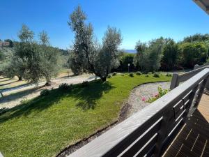 サンタ・ルーチェにあるGlamping Tuscany - Podere Cortesiの家のバルコニーから庭園の景色を望めます。