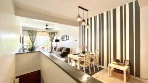 a kitchen and living room with a striped wall at The Roomah in Bentong
