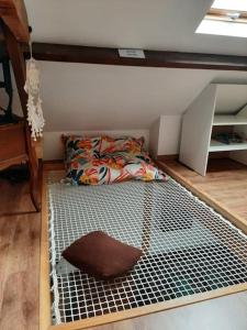 a bed with a metal bed frame in a room at Maison proche gare et commodités in Le Mans