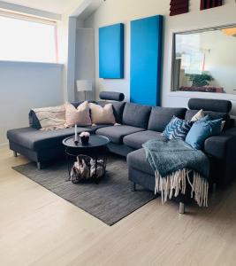 a living room with a blue couch and a table at Country guesthouse in Gadstrup