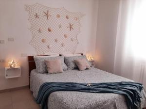 a bedroom with a bed with a star headboard and pillows at Riccione la casetta del paese in Riccione
