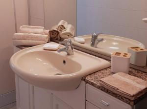 a white bathroom with a sink and a mirror at Riccione la casetta del paese in Riccione