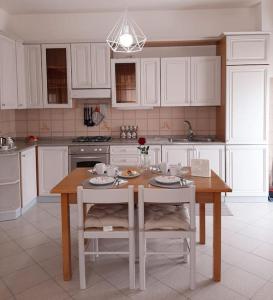 a kitchen with a table and two chairs and a table at Riccione la casetta del paese in Riccione