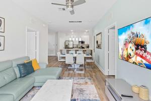 a living room with a couch and a tv at The Epic Dublin Vista Cay Orlando in Orlando