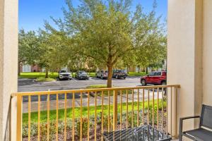 a balcony with a tree and a street at The Epic Dublin Vista Cay Orlando in Orlando +91 photos