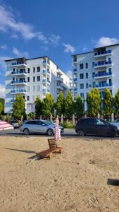 a child sitting on a chair on the beach at Tushemisht Lake View Studio Apartment in Pogradec