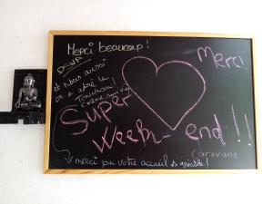 a chalk board with a heart written on it at Caravane Eriba au Bord de l'Eure in Neuilly