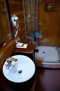 a bathroom with a sink and a shower at Belka-Hotel in Yuzhno-Sakhalinsk