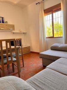 uma sala de estar com uma mesa e uma cadeira em APARTAMENTO LA MURALLA 2 em Córdoba