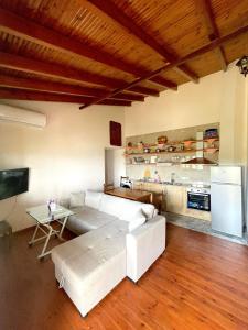 a living room with a white couch and a table at Villa Anna in Sarandë