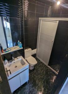 a bathroom with a toilet and a sink and a shower at appartement luxueux in Agadir