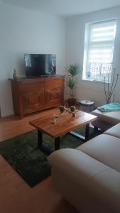 a living room with a coffee table and a tv at Brockensicht in Ilsenburg