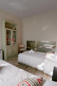 a bedroom with two beds and a chair at Armonia-Art House in Kos