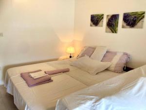 a bedroom with a large bed with two towels on it at Apartment Nadallina in Jelsa