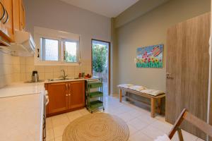 a kitchen with a sink and a bench in a room at Armonia-Art House in Kos