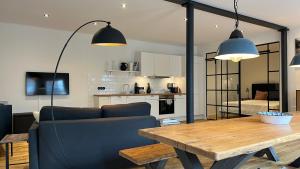a living room with a couch and a wooden table at Loftwohnung 1 Simmerdeis an der Gracht in Friedrichstadt +32 photos