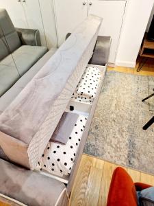 aption of a couch in a living room at Beautiful Hyde Park Flat by Lancaster Gate Station with Private Back Patio in London