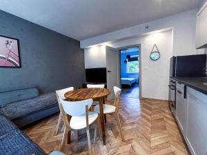 a kitchen and dining room with a table and chairs at Apartament Centrum B in Wejherowo