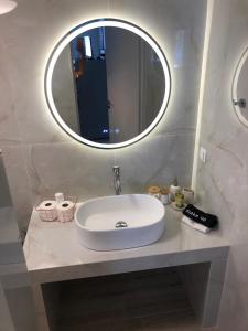 a bathroom with a sink and a mirror at Villa Elia Perigiali Lefkada in Nydri