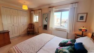 a bedroom with a large bed and a window at Sail Away in Eastbourne