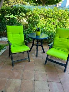 ベラにあるDuplex Vera - Playaの緑の椅子2脚、鉢植えのテーブル