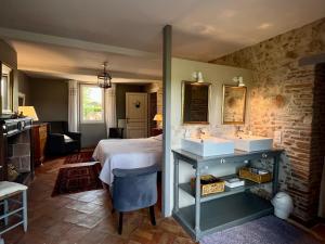 a bedroom with a bed and two sinks in it at Le Mas De Marie in Lavaur