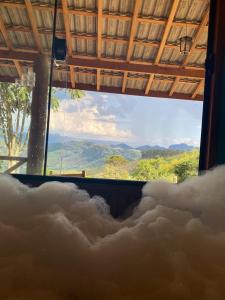 a room with a view of a room filled with smoke at Chalé da Sorte in Gonçalves