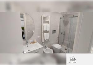 a bathroom with a sink and a toilet and a shower at Gaia's House in Massa Lubrense