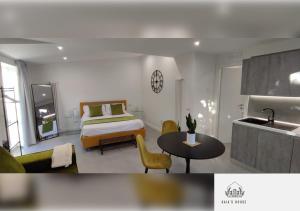 a bedroom with a bed and a table and a kitchen at Gaia's House in Massa Lubrense