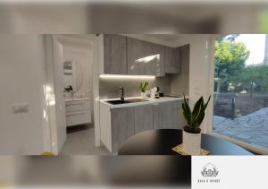 a rendering of a kitchen with a sink and a window at Gaia's House in Massa Lubrense