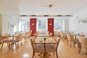 a dining room with wooden tables and chairs at Hotel Hirschen in Zürich
