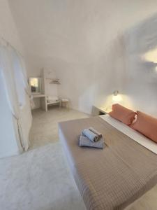a bedroom with a bed with a towel on it at Otto house - Luxury cave home in Vóthon