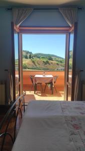 a room with a table and a large window at Gran Sasso Letizia BB in Filetto