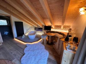 vistas panorámicas a una sala de estar con techos de madera en Rifugio Caltena, en Fiera di Primiero