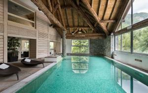 a pool in a house with a swimming pool at Lagrange Vacances L'Ardoisière in Saint-Lary-Soulan