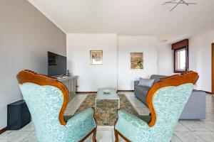 een woonkamer met 2 stoelen en een bank bij La casa dell'artista in Verona