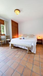 a bedroom with a large white bed in a room at Villa del Jerte in El Torno