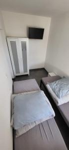 a room with two beds and a mirror at Noclegi Tuszyn in Tuszyn +3 photos