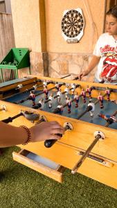 a table with a dart board with people playing darts at Villa del Jerte in El Torno